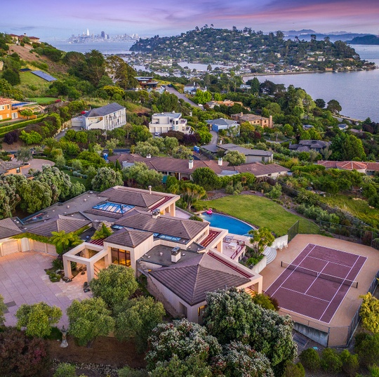 Modern Marin hillside home with a swimming pool, tennis court, and views of the bay and San Francisco skyline.